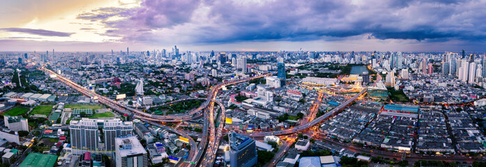 Wall Mural - aerial view of bangkok skyline and skyscraper with light trails on express way in center of business