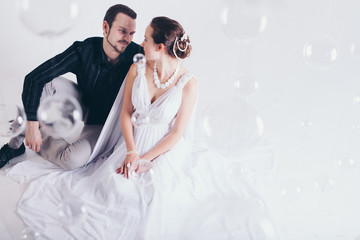 portrait of a man and a woman on a white background. Pair in suit and dress