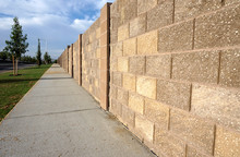 Block Wall In Neighborhood With Sidewalk