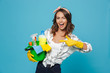 canvas print picture - Photo of pleased young housemaid 20s wearing yellow rubber gloves for hands protection holding bucket with cleaning supplies, isolated over blue background