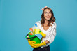 © Drobot Dean - Image of european woman 20s wearing yellow rubber gloves for hands protection holding bucket with detergents, isolated over blue background