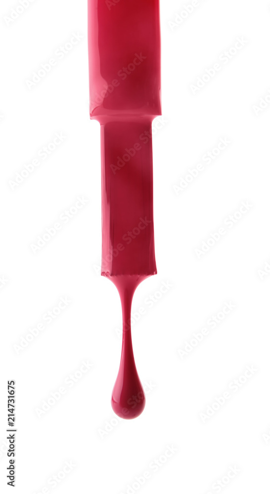 Brush with dripping nail polish on white background