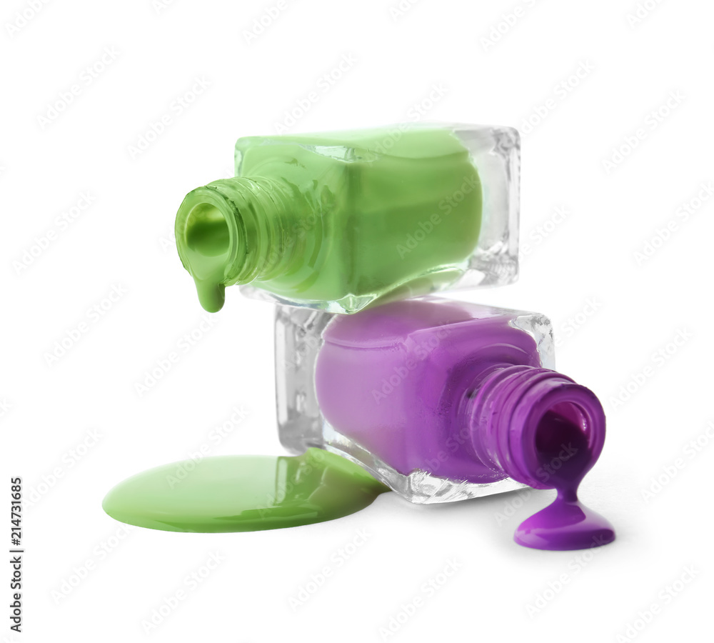 Open bottles with dripping nail polishes on white background