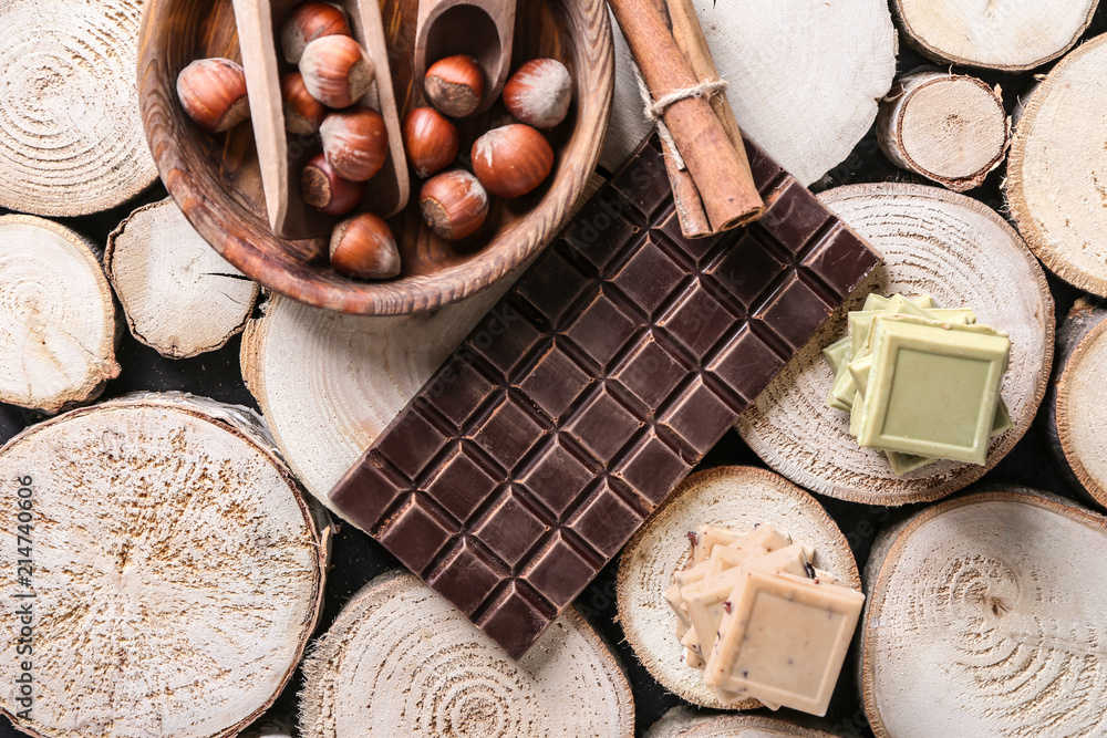 Different chocolate pieces with nuts on wooden stumps