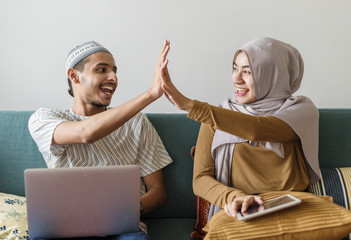 Wall Mural - Muslim family using digital devices at home