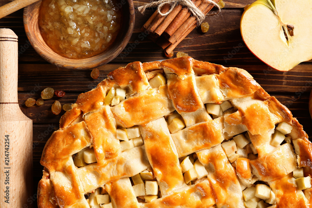 Composition with delicious apple pie on wooden table