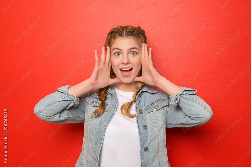 Emotional young woman on color background