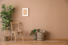 Wooden Chair With Wicker Basket And Plant Near Color Wall
