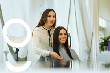 Pleasant communication. Positive joyful woman talking to her client while giving advice