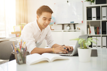 Asian young businessman working at his office.