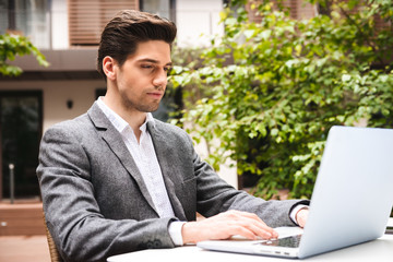 Wall Mural - Confident young businessman dressed in suit