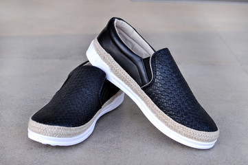 Trendy black moccasins. Fashionable women's leather shoes.Beauty and fashion concept. 