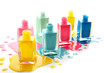 Open bottles of nail polishes on white background