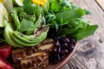 Wall Mural - Bowl with abocado and colorful vegetables, healthy vegan meal