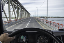 A View From The Driver's Cab Of A Truck Moving Along An Asphalt Summer Road.