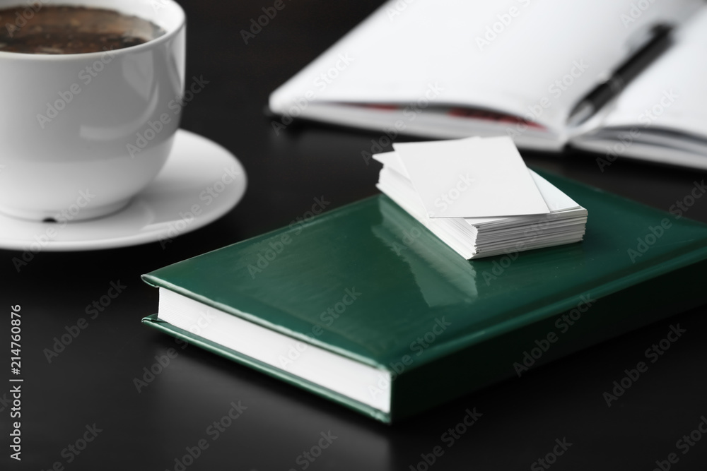 Blank business cards with notebook on table