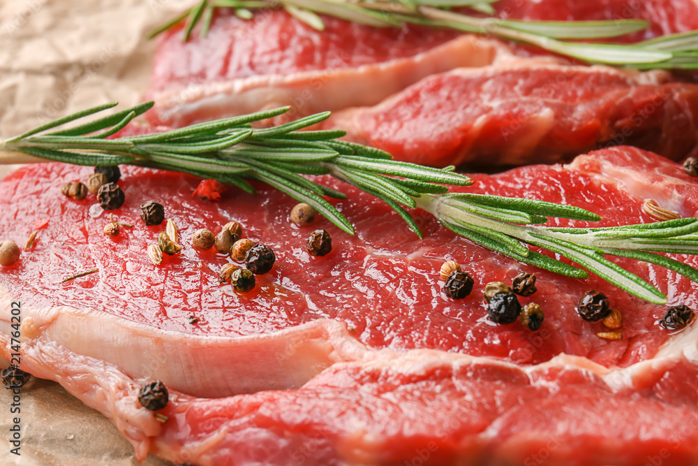 Raw meat with spices and rosemary, closeup