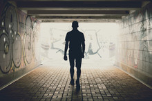 Silhouette Of A Man Walking On An Underground Pedestrian Crossing
