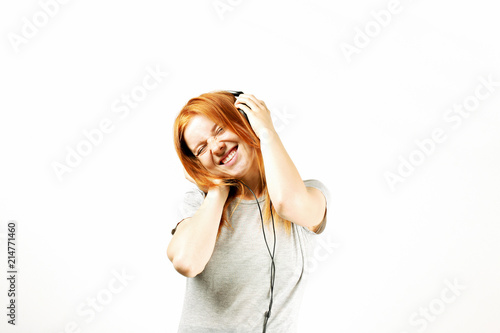 Young Attractive Natural Redhead Woman Smiling Dancing Singing Along To Her Favorite Song With Large Headphones White Background Copy Space Attractive Female In Casual Outfit Enjoying Beloved Tune Buy This Stock