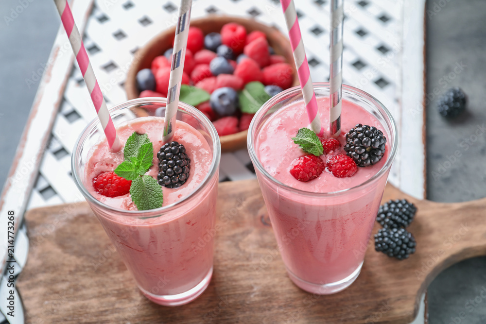 Glasses with tasty raspberry smoothie on table