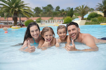 Wall Mural - Cheerful family in hotel swimming-pool