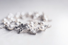 Pearl Silver Necklace On A White Background Close-up In The Defocus