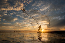 Fisherman Cast A Net At Lake In The Moring Time , Silhouette Light
