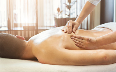 Young man receiving back massage