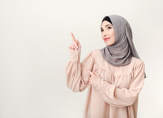 Wall Mural - Islamic woman in hijab pointing on copy space