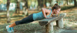 © Microgen - Woman doing push ups in the park, in the fall.