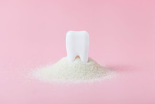 Plastic Tooth In Big Pile Of Sugar.