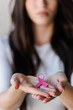 © lordn - Young woman holding pink breast cancer awareness ribbon