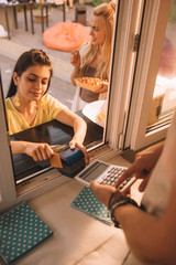 Sticker - high angle view of customer paying with credit card at food truck