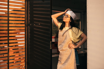 Wall Mural - attractive chef posing in food truck