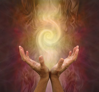 channeling golden vortex healing energy - female hands held open and palms upwards with a vortex ene