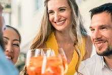 Beautiful Woman And Her Best Friends Toasting With A Refreshing Alcoholic Drink While Sitting Together At Table Outdoors In A Trendy Restaurant In Summer