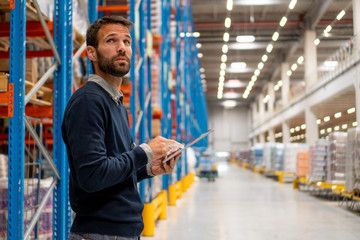 Sticker - Manager in warehouse holding digital tablet