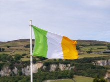 Irish Flag With Countryside In The Background