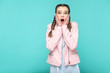 © khosrork - wow its unbelievable, portrait of beautiful cute girl standing with makeup and brown pigtail hairstyle in striped light blue shirt pink jacket. indoor, studio shot isolated on blue or green background