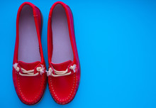 Red Moccasins On A Blue Background