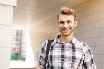 Wonderful mood. Portrait of a happy young man while smiling to you