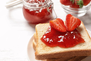 Tasty toast bread with strawberry jam and fresh berries on light background, closeup