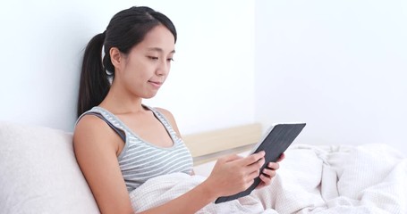 Sticker - Woman use of tablet computer on bed