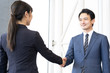 © taka - asian business team shaking hands