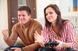 © Aleksei Lazukov - young man won his girlfriend in the video game. a young woman was upset