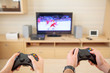 © Aleksei Lazukov - man and woman playing video game hockey with joysticks