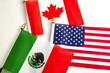 North American Free Trade Agreement or Nafta and 2026 football world cup organizing countries concept with close up on the flags of Mexico, USA and Canada