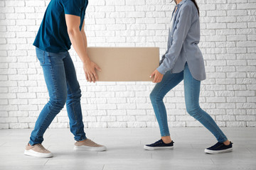 Sticker - Young couple carrying big moving box at new home