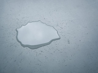 Liquid or water drops splash on the floor , Dark color tone, abstract background