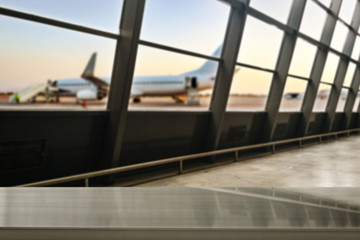 Wall Mural - wooden desk of free space and airport background with big window